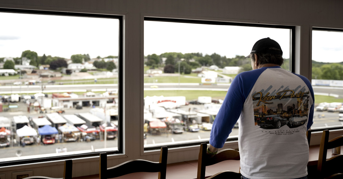A fan watching the track through the windows of the air conditioned indoor vista suite